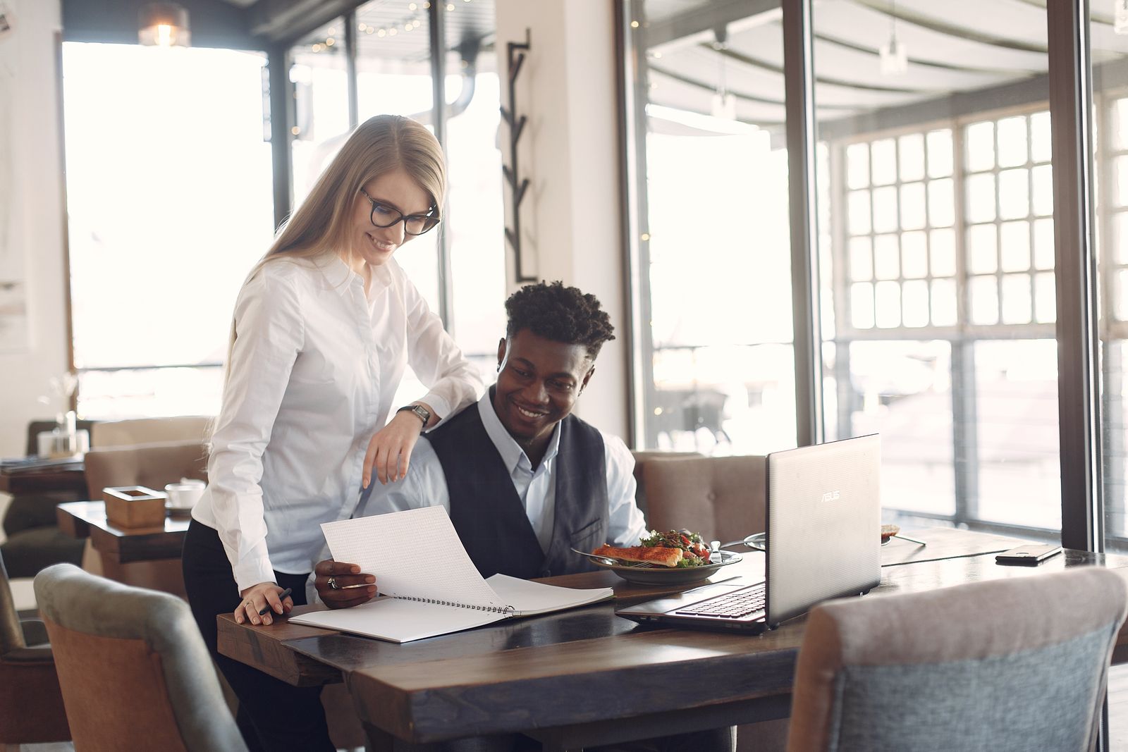 Colleagues planning work together in a café